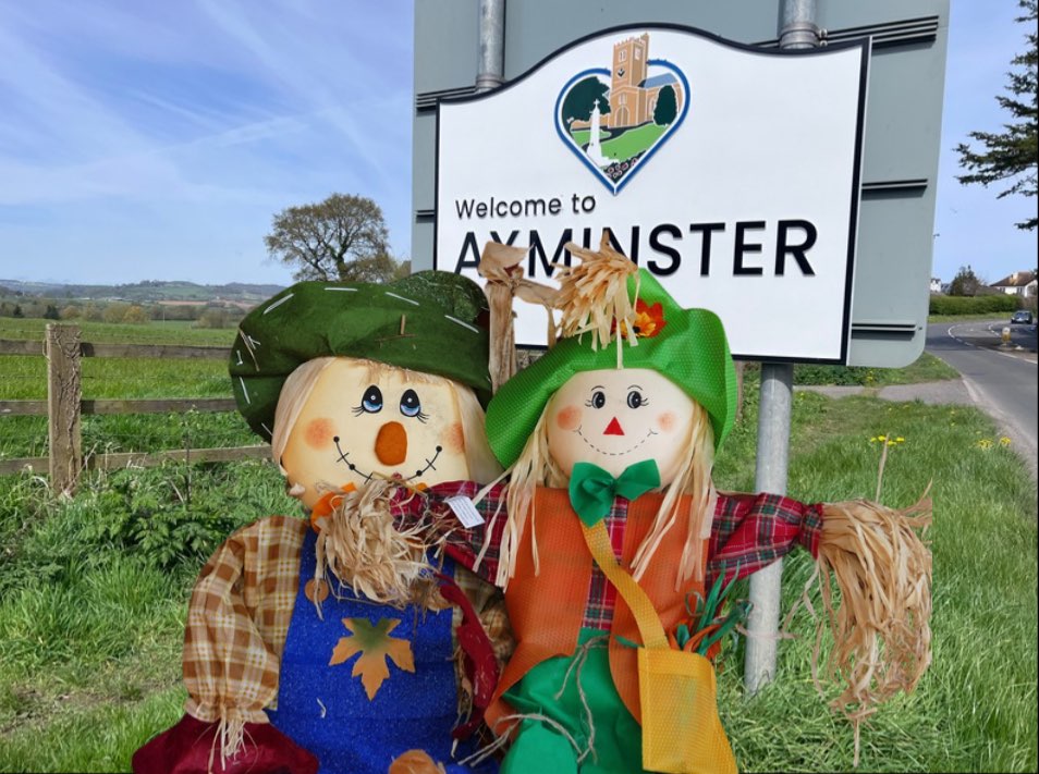 Scarecrows with Axminster town sign